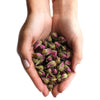 A cup of pink rose buds with delicate dried petals showing soft pink and green natural textured hues
