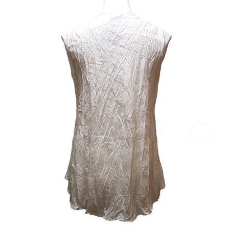 A sleeveless white cotton vest top with textured fabric and an asymmetrical hemline in plain cotton material