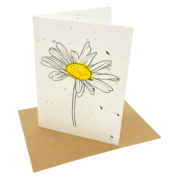 A white seed paper greetings card with a black-lined daisy and yellow center on a brown kraft envelope