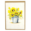 A plantable greetings card with a watercolor illustration of sunflowers in a silver bucket on sunflower seed paper