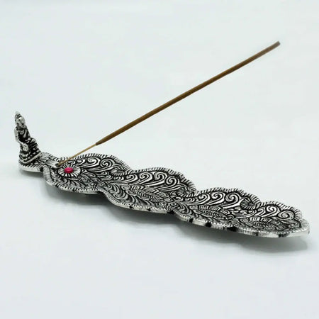 Polished aluminium incense holder with silver peacock feather design and small red gemstone accent for burning sticks
