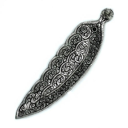Silver-toned metal leaf brooch with swirling patterns shown beside a polished aluminium incense holder buddha long shaped