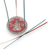 Red and silver polished aluminium incense holder with buddha design enameled details and green and red incense sticks hanging