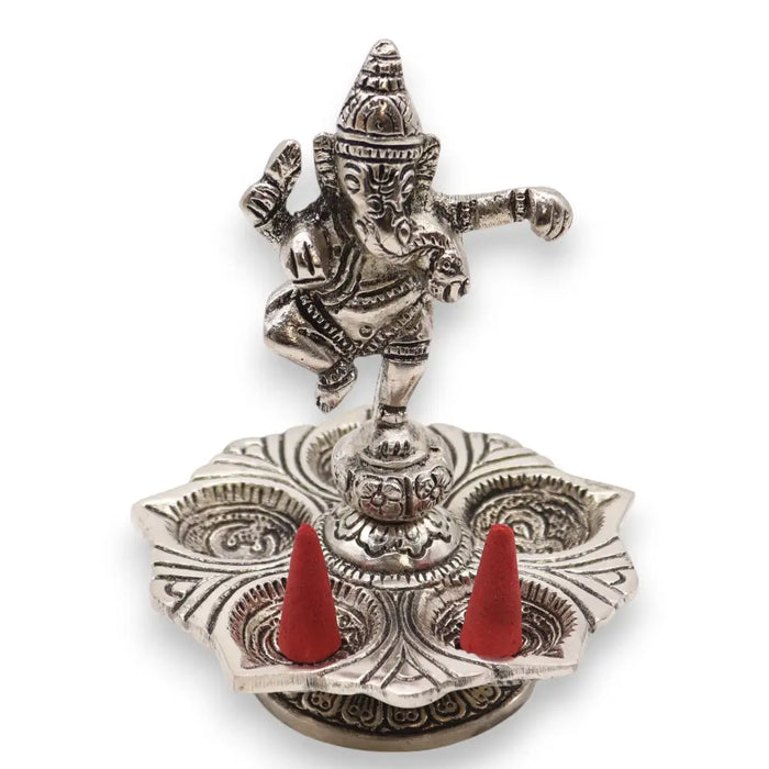 Silver-colored polished aluminium incense holder with dancing ganesha figurine and two red cone incense sticks