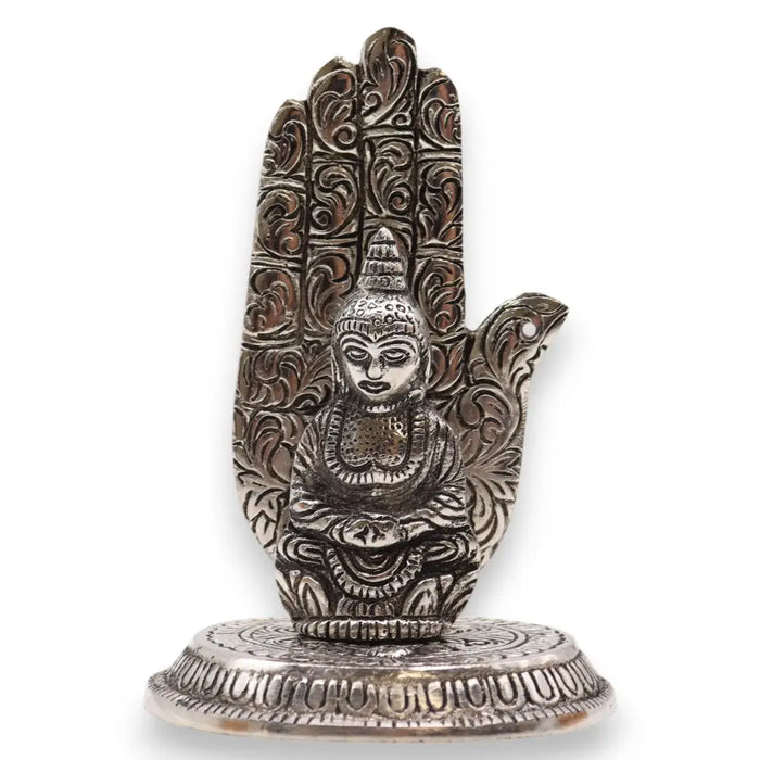 Silver-colored polished aluminium incense holder with a seated buddha inside an intricately carved hand base