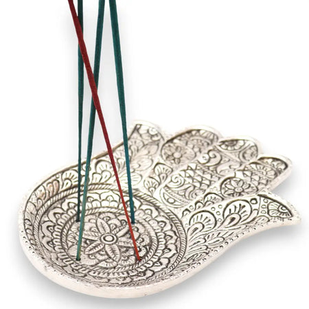 Polished aluminium incense holder shaped like a large silver hamsa hand with intricate floral and geometric embossing