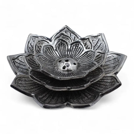 Black metal lotus-shaped incense holder with detailed petal carvings and central hole made of polished aluminium