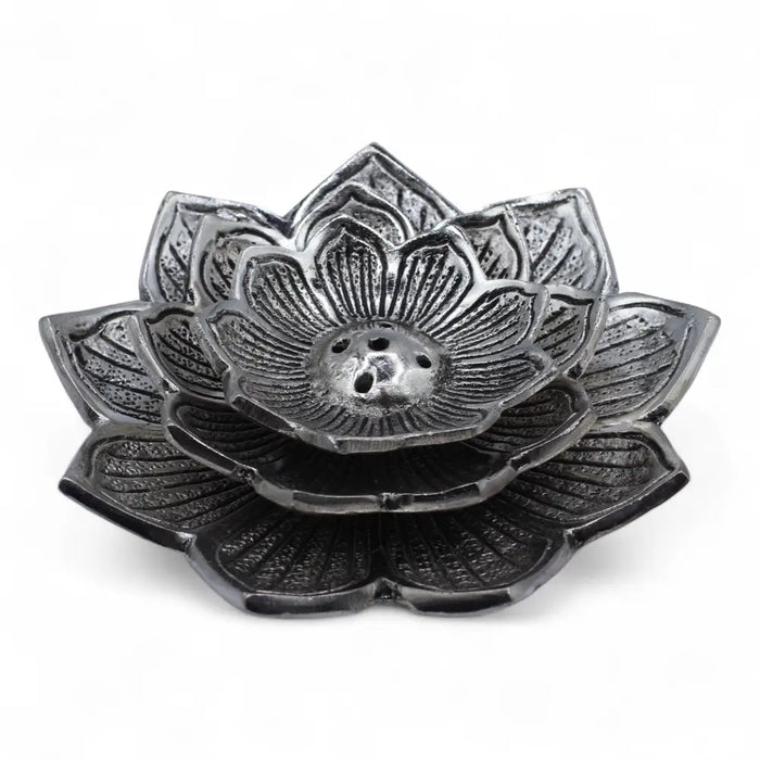 Black metal lotus-shaped incense holder with detailed petal carvings and central hole made of polished aluminium