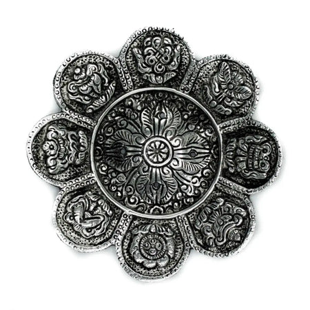 Silver-toned flower-shaped polished aluminium incense holder with intricate engraved tibetan symbols on each petal