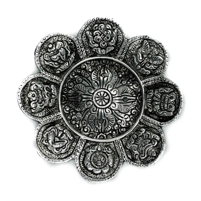 Silver-toned flower-shaped polished aluminium incense holder with intricate engraved tibetan symbols on each petal