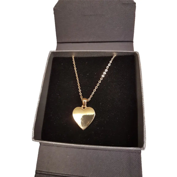 Polished gold-tone heart pendant necklace with delicate chain displayed in a black gift box