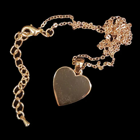 Gold-tone heart pendant necklace with a polished finish on a delicate chain and clasp