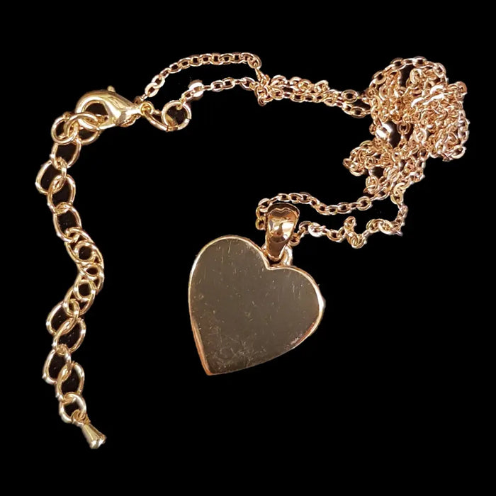 Gold-tone heart pendant necklace with a polished finish on a delicate chain and clasp