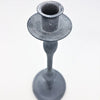 A powdered grey metal candlestick with a matte textured finish and classic tapered metal candlestick design
