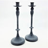 Pair of grey metal candlestick holders with dark powdered finish and classic tapered design with flared bases