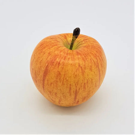 A premium artificial fruit coxs orange pippin apple with glossy golden yellow skin, red streaks, and a dark brown stem