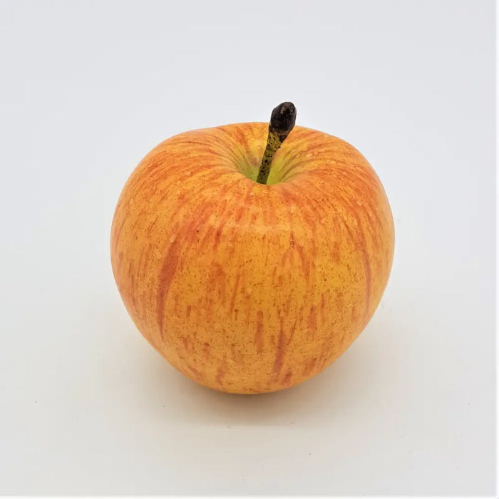 A premium artificial fruit coxs orange pippin apple with glossy golden yellow skin, red streaks, and a dark brown stem