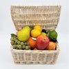 A light beige woven wicker fruit basket filled with colorful premium artificial coxs orange pippin apples and mixed fruit