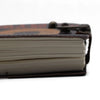 Brown leather notebook with metal clasp and cream pages in a printed leather notebook stop doom scrolling design