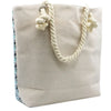 Beige canvas psychedelic splash bag with twisted rope handles and a floral patterned side panel called pure energy