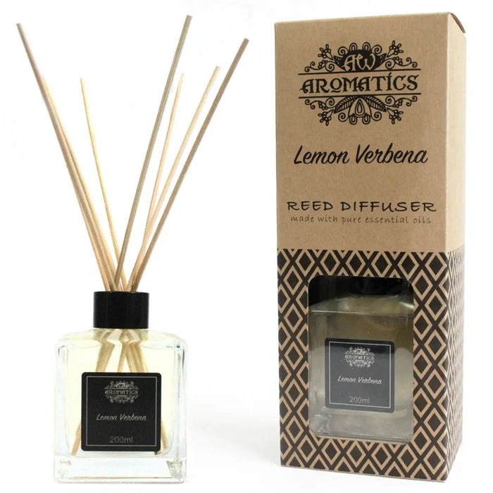 A clear glass reed diffuser bottle with black cap and pale yellow lemon verbena essential oils and wooden reeds
