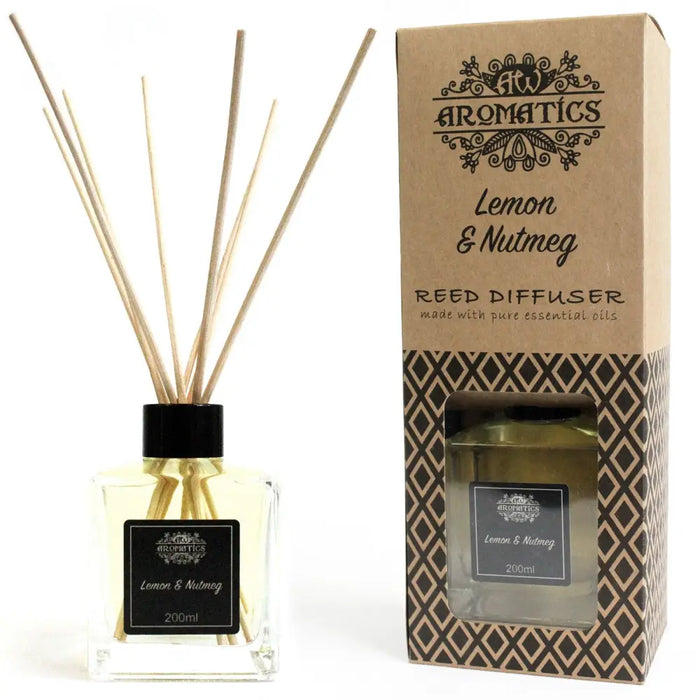 A clear glass reed diffuser with black cap filled with pale yellow lemon and nutmeg essential oils and wooden reeds