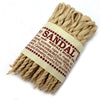 A beige twisted sandalwood rope incense with a paper label wrapped around the center for aromatic use