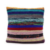 A vibrant handwoven rag rug cushion cover in charcoal greys with multicolored stripes of teal purple red and beige yarns
