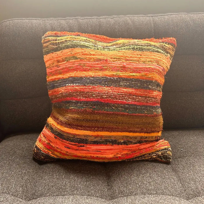 Vibrant handwoven rag rug cushion cover sunrise oranges with textured horizontal stripes in orange red yellow dark tones