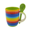 Rainbow-striped ceramic mug with a matching green spoon resting in its handle for easy use