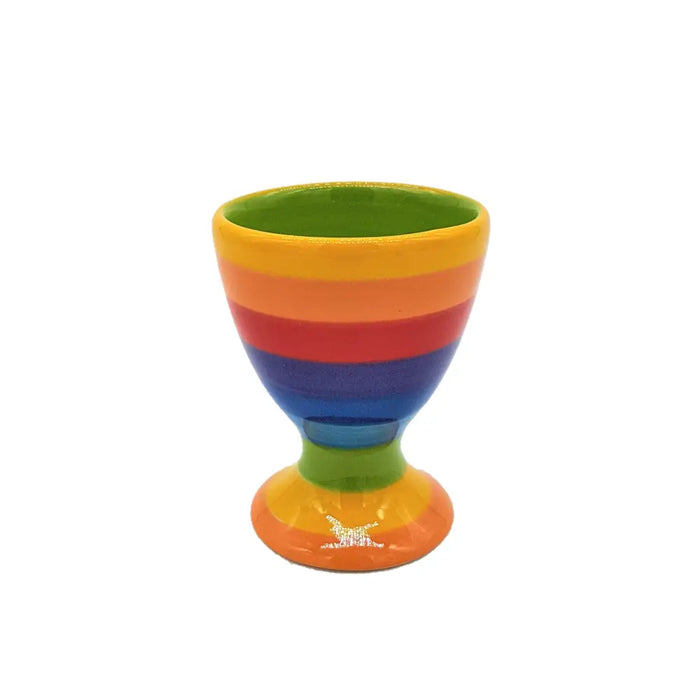 Rainbow-striped ceramic egg cup with green interior and a small white horse design on the base