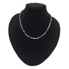 A delicate rainbow hematite peninsular necklace with silver rectangular beads and blue green purple gemstone accents