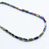 Rainbow hematite peninsular beaded necklace with iridescent rectangular beads and metallic connectors