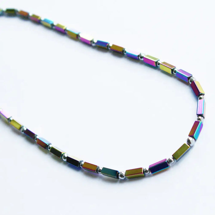 Rainbow hematite peninsular beaded necklace with iridescent rectangular beads and metallic connectors