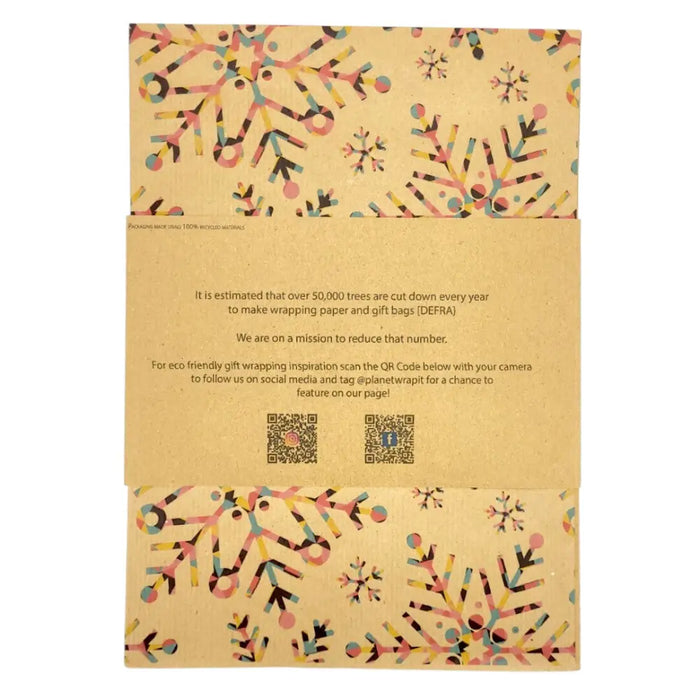 Beige recycled kraft wrapping paper with colorful pink yellow blue and black snowflake patterns on kraft paper sheet