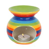 Rainbow stripe ceramic oil burner with rainbow stripes and a lit tealight candle inside for aromatherapy use