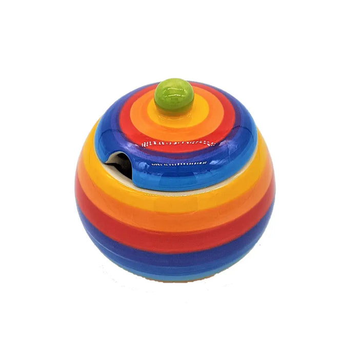Vibrant rainbow-striped ceramic sugar bowl with lid featuring a green spherical knob on top