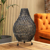 Dark gray woven rattan table lamp with diamond lattice design and black metal feet featuring a plug fitting