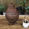 Brown woven rattan table lamp with teardrop shape natural rattan and plug fitting on black spherical feet