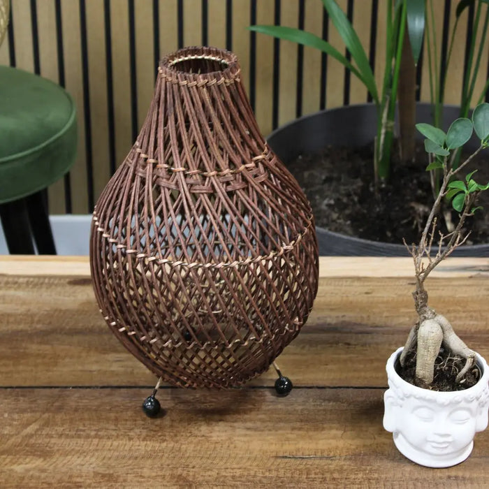 Brown woven rattan table lamp with teardrop shape natural rattan and plug fitting on black spherical feet