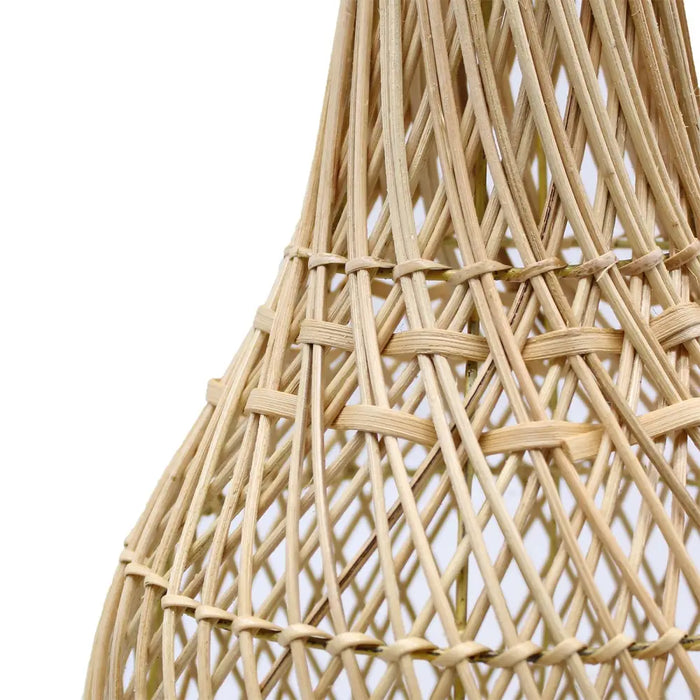 Natural beige rattan table lamp with woven geometric pattern casting delicate shadows in natural rattan material