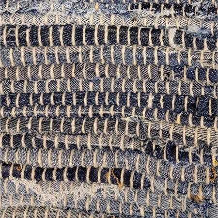 Blue and white denim strips woven into a textured chindi rag cushion cover for standard cushions
