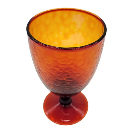 A textured amber recycled glass wine glass with a dark rim and base for serving wine or drinks