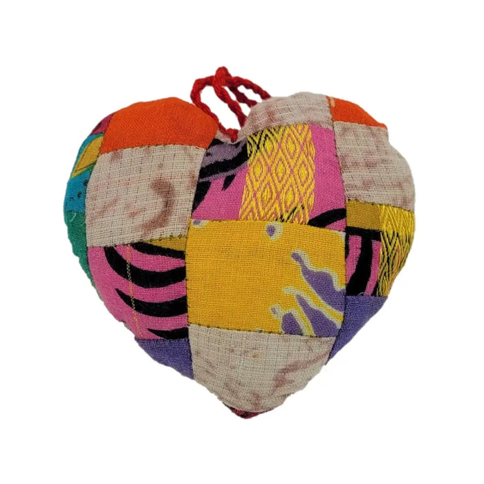 A colorful heart-shaped hanging decoration made from assorted recycled sari silk fabrics with a red drawstring