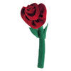 A plush red fabric rose with a green stem and leaves next to a crackle glazed terracotta plant pot