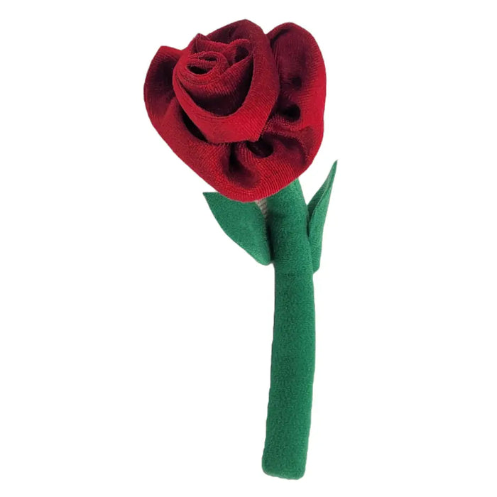 A plush red fabric rose with a green stem and leaves next to a crackle glazed terracotta plant pot