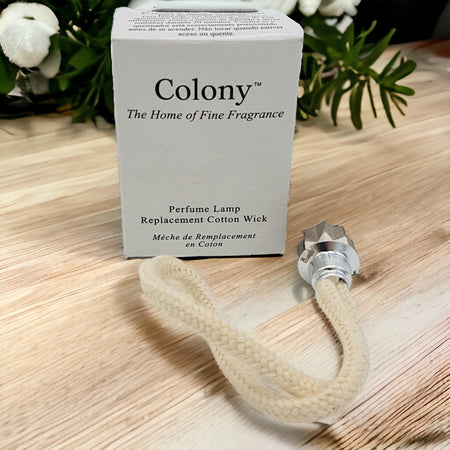 Cream-colored braided cotton wick with a metallic star-shaped cap for replacement in colony perfume lamps