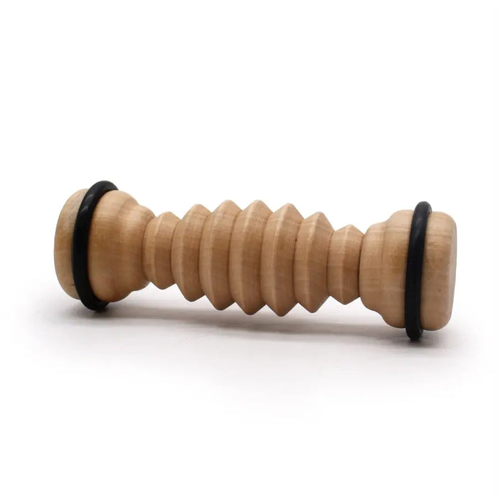 Light wooden ribbed foot roller with black rubber ends made for foot massage and relief