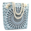 A sky blue and black mandala canvas tote bag with thick beige rope handles for casual use