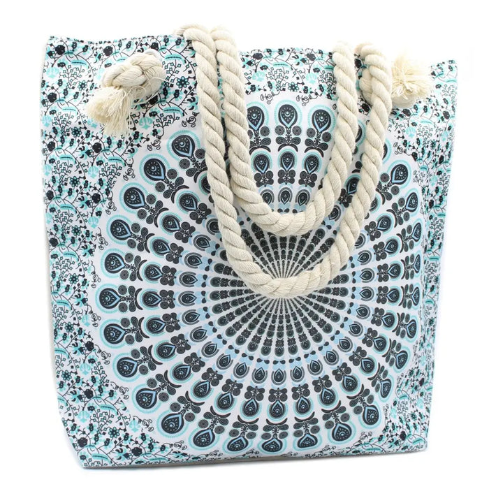 A sky blue and black mandala canvas tote bag with thick beige rope handles for casual use